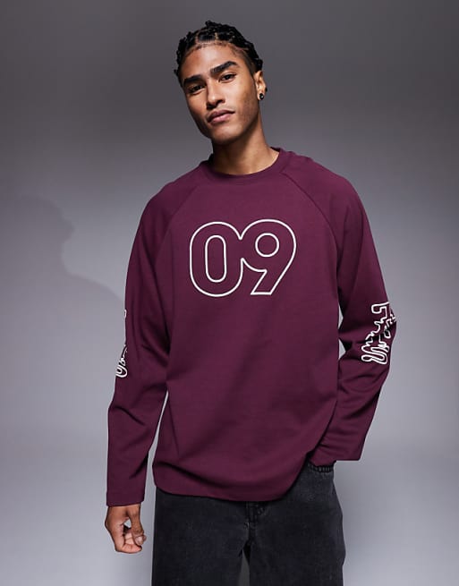 ASOS DESIGN oversized raglan long sleeve t-shirt with flocked sports graphic in burgundy