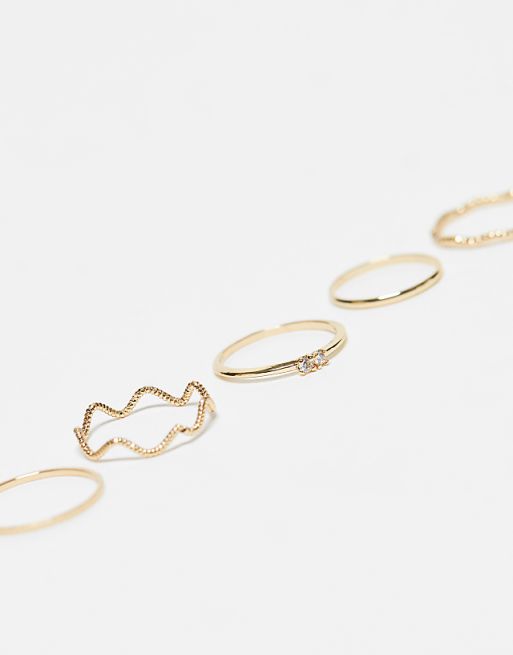 ASOS DESIGN Pack Of 12 Rings With Twist Details And Engraved Designs In Gold Tone