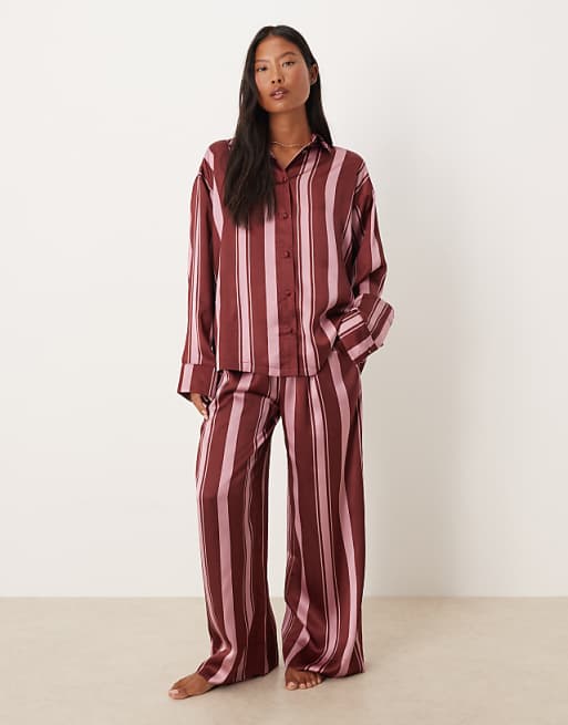 ASOS DESIGN Petite oversized satin stripe shirt and trouser pyjama set in burgundy stripe