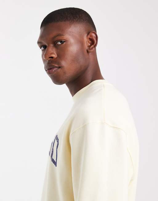 ASOS DESIGN Relaxed Fit Sweatshirt With Distressed Text Embroidery In Pale Yellow