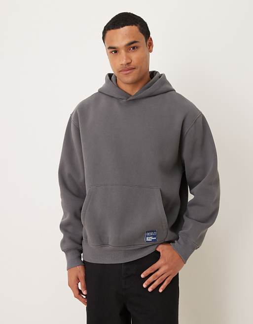 ASOS DESIGN relaxed hoodie with woven label in washed charcoal