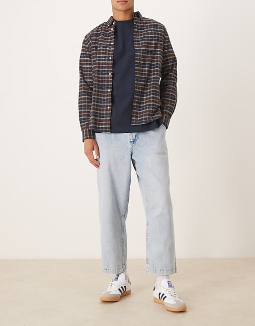 ASOS DESIGN relaxed tapered pleated jeans in bleach wash denim