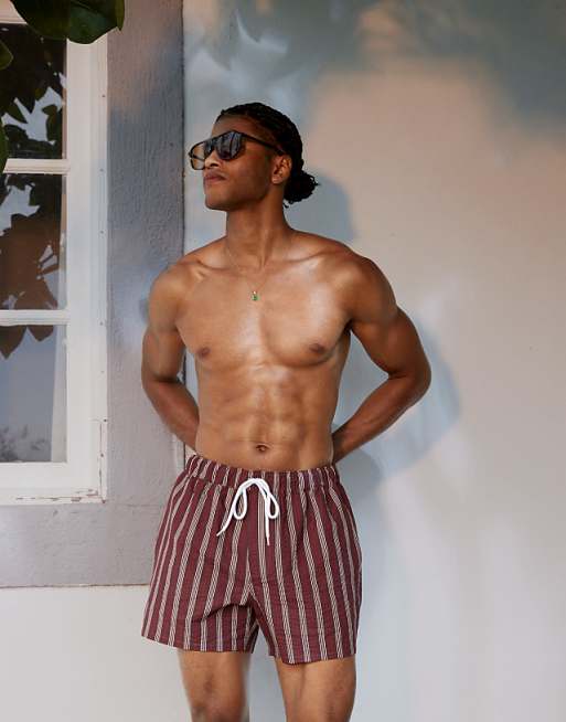 ASOS DESIGN seersucker swim shorts in short length in burgundy stripe