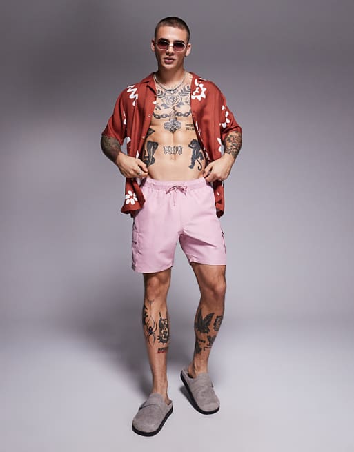 ASOS DESIGN swim shorts in mid length with cargo pockets in pink