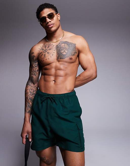 ASOS DESIGN swim shorts in mid length with cargo pockets in green