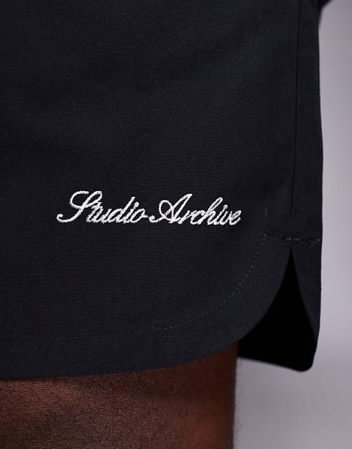 ASOS DESIGN Swim Shorts In Mid Length With Embroidery Placement In Black