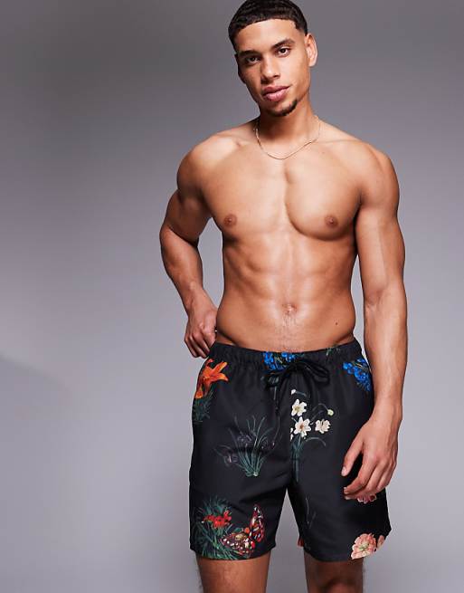 ASOS DESIGN swim shorts in mid length with floral print in black