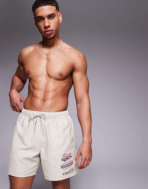 ASOS DESIGN swim shorts in mid length with placement print in beige