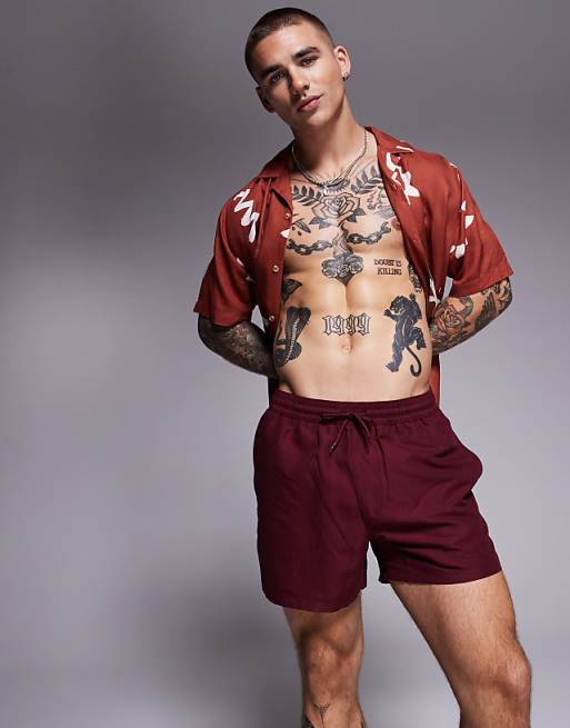 ASOS DESIGN swim shorts in short length in burgundy