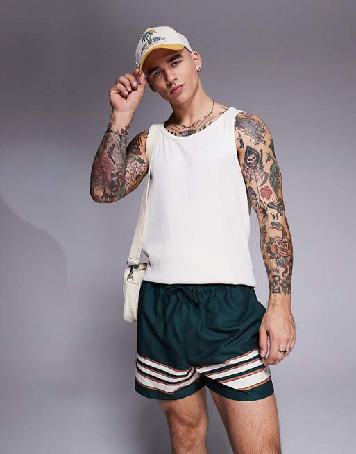ASOS DESIGN swim shorts in short length in green with border stripe