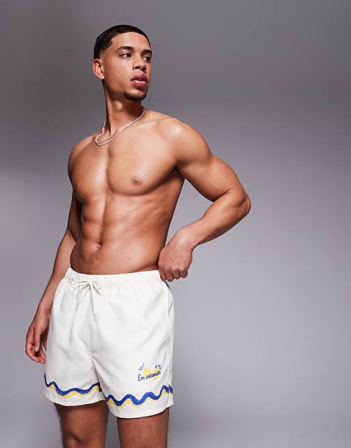 ASOS DESIGN swim shorts in short length with border print in stone