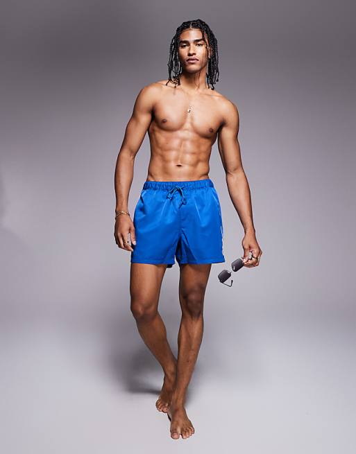 ASOS DESIGN swim shorts in short length with embroidery in blue