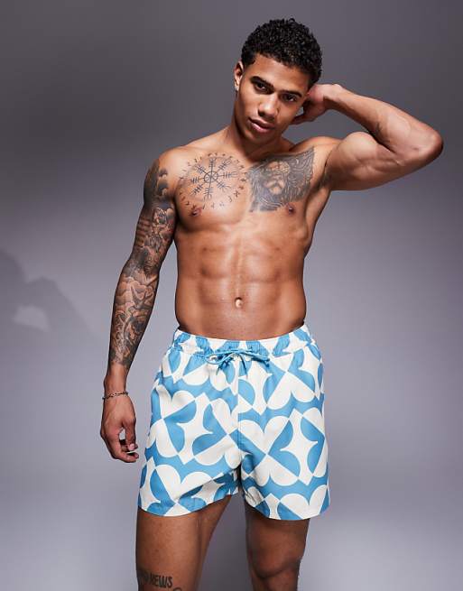 ASOS DESIGN swim shorts in short length with geo print in blue