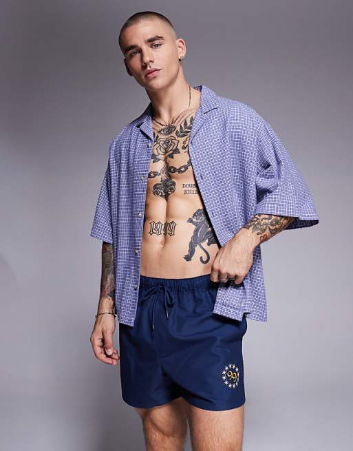 ASOS DESIGN swim shorts in short length with placement print in navy
