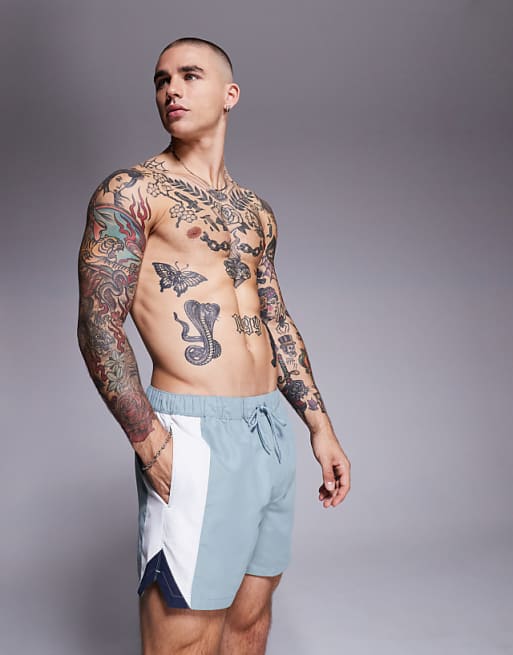 ASOS DESIGN swim shorts in short length with side vent cut and sew in blue