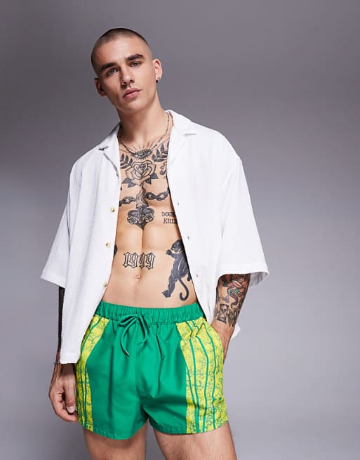 ASOS DESIGN swim shorts in super short length with placement animal print in green