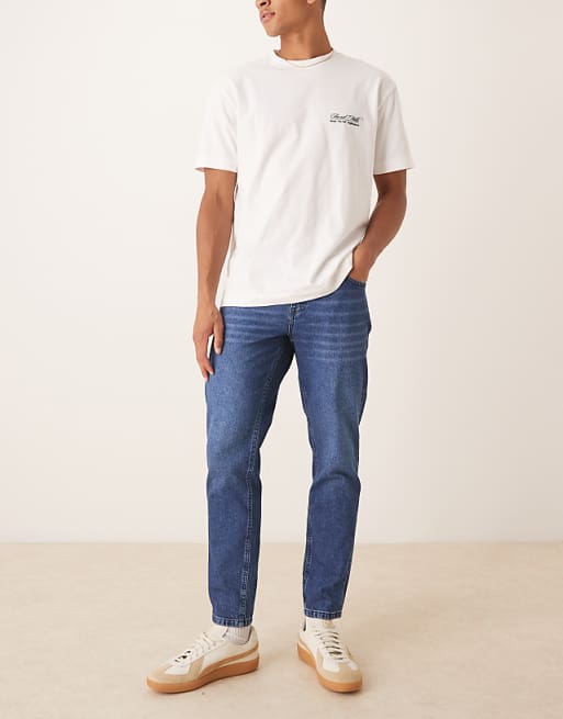 ASOS DESIGN tapered fit jeans in dark wash blue