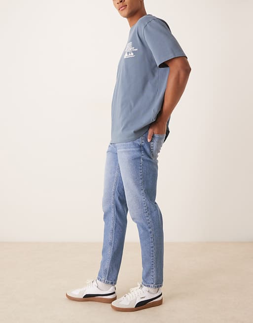 ASOS DESIGN Tapered Fit Jeans In Light Wash Blue