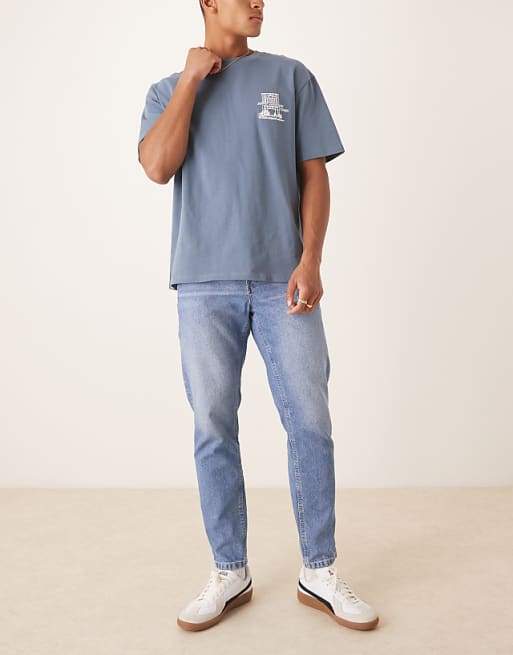 ASOS DESIGN tapered fit jeans in light wash blue