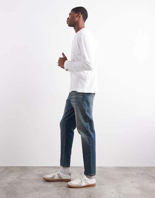 ASOS DESIGN Tapered Fit Jeans With Tint In Mid Wash Blue