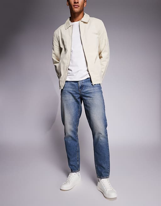 ASOS DESIGN tapered jeans in mid wash with tint