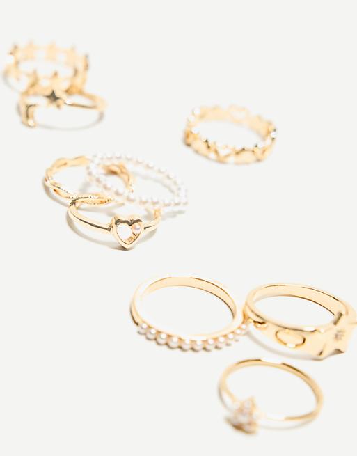 Bershka 9 pack of thin faux pearl rings in gold