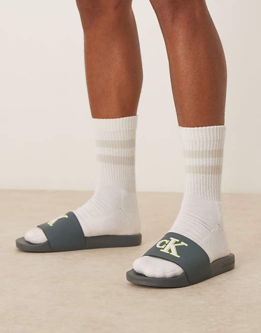 Calvin Klein Jeans large logo sliders in teal lime and white
