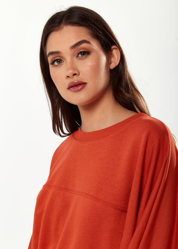 Liquorish Women's Cropped Sweatshirt In Dark Orange With Voluminous Bat And Balloon Sleeves Elastic Cuffs And A Chic Design