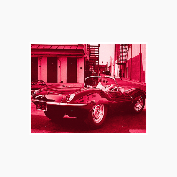 liv corday Steve McQueen in his Jaguar in Red