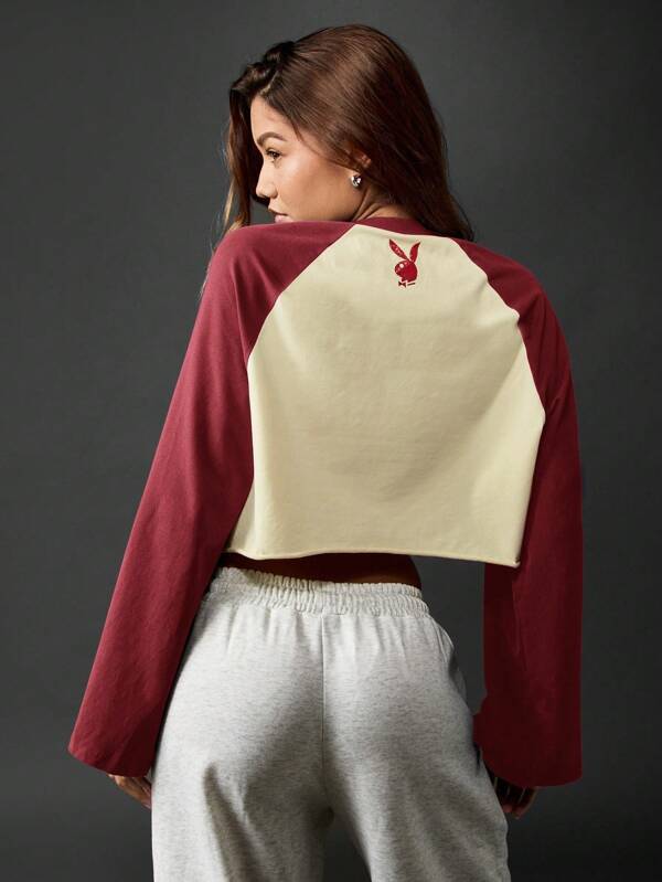 Missguided Missguided X Playboy MISSGUIDED Raglan Sleeve Cropped Baseball Sweatshirt With Distressed Logo