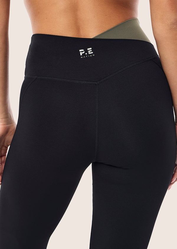 p.e nation Wander flare legging in black & dusty olive