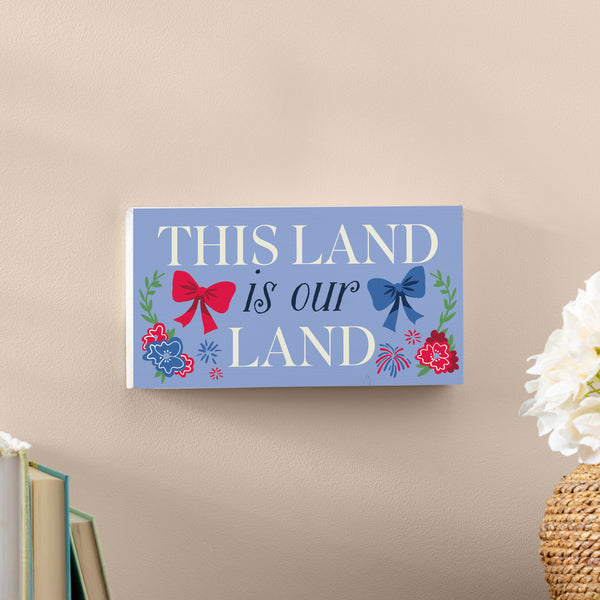 Plow & Hearth American Classic Red White & Bows Wood Hanging Sign W/ Rope "This Land Is Our Land" 11"x6"