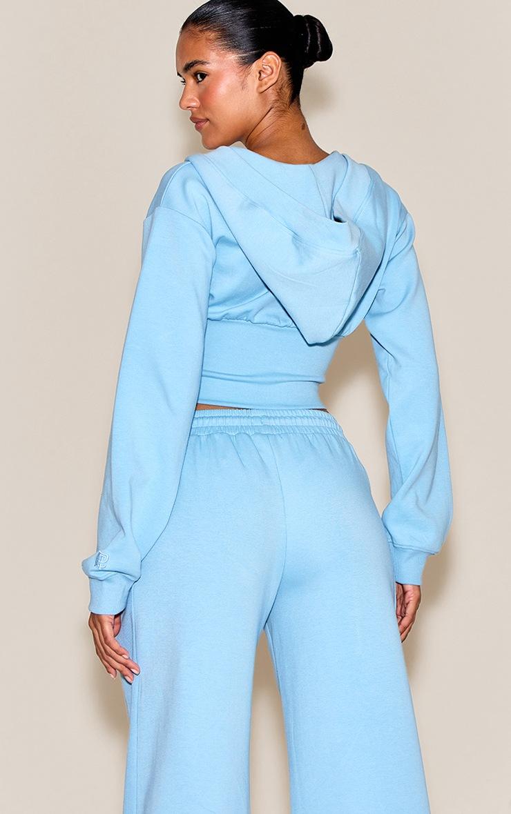 Pretty Little Thing Baby Blue Embroidered Interlock Cinch Waist Zip Hoodie