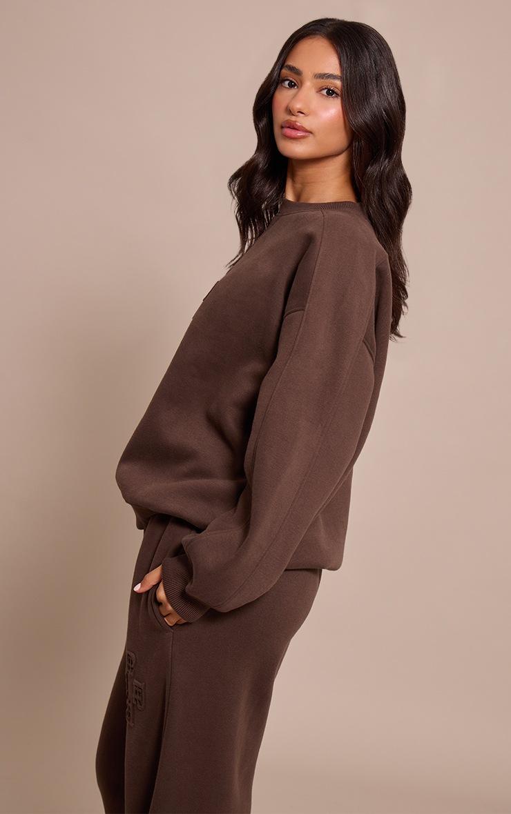 Pretty Little Thing Petite Chocolate PLT Embossed Crew Neck Sweatshirt