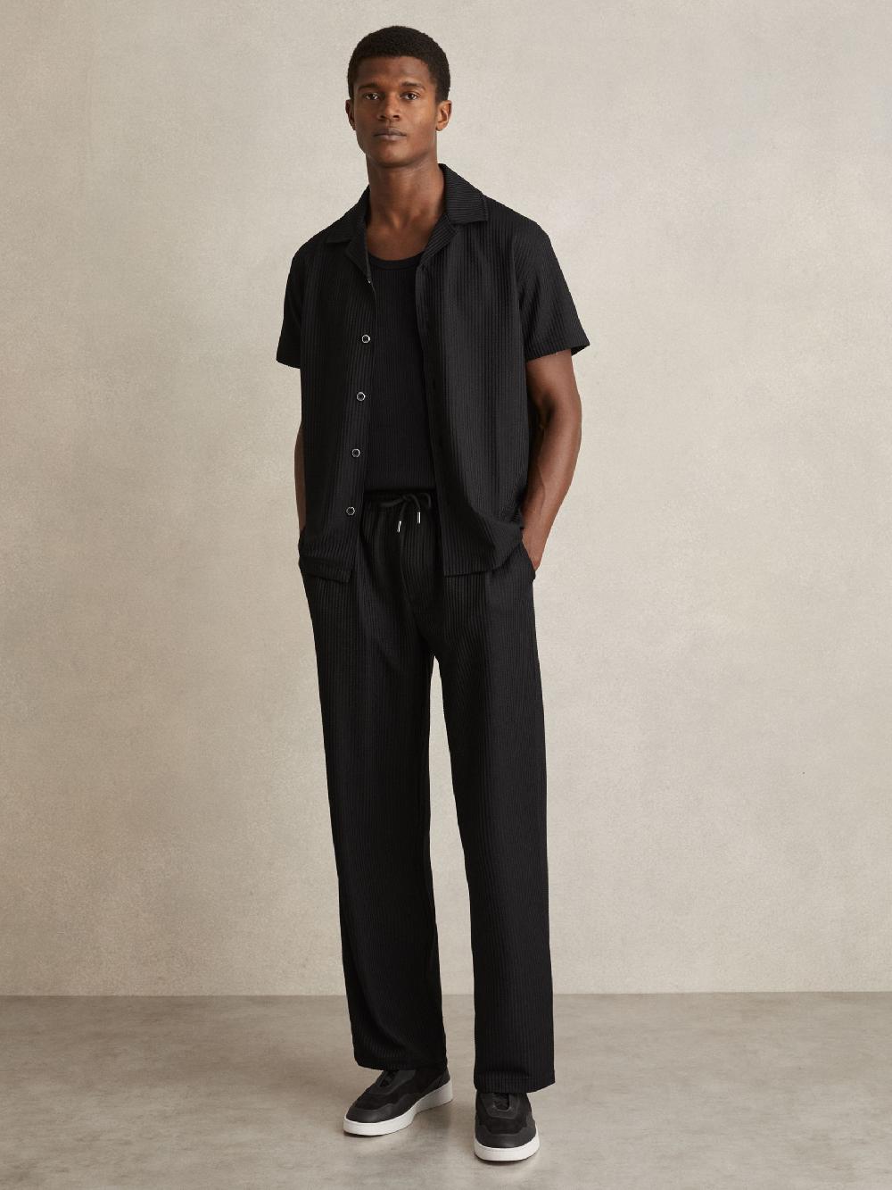 Reiss Textured-Knit Tapered Trousers In Black