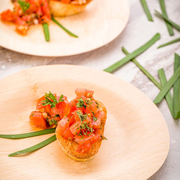 Restaurantware Bambuddha Round Natural Bamboo Medium Veneer Plate - 7" X 7" X 1/2" - 100 Count Box