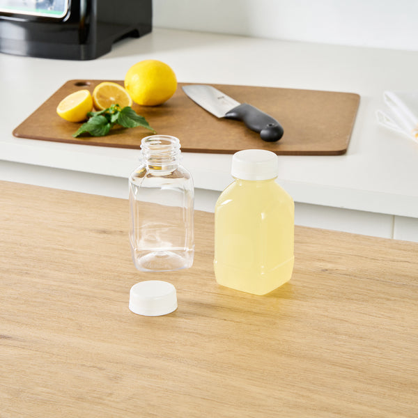 Restaurantware Bottle Tek 8 Oz Square Clear Plastic Cold Pressed Juice Bottle - With Safety Cap - 2 1/4" X 2 1/4" X 4 3/4" - 100 Count Box