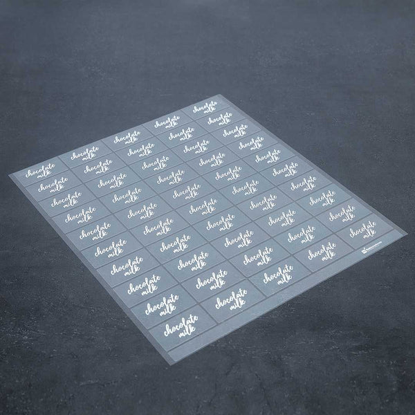 Restaurantware Label Tek Plastic Chocolate Milk Label - Clear With White Font Water-Resistant - 2" X 1" - 100 Count Box