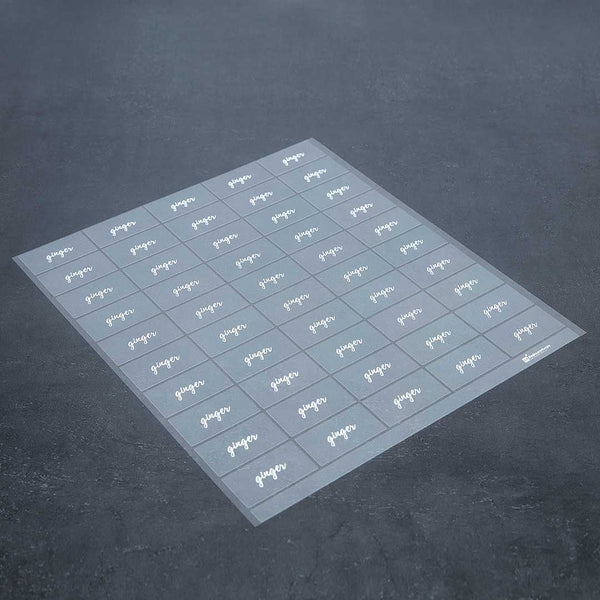 Restaurantware Label Tek Plastic Ginger Label - Clear With White Font Water-Resistant - 2" X 1" - 100 Count Box