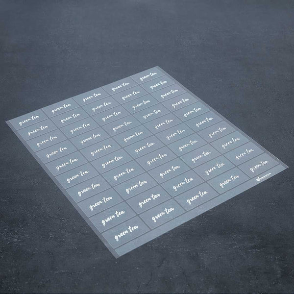 Restaurantware Label Tek Plastic Green Tea Label - Clear With White Font Water-Resistant - 2" X 1" - 100 Count Box