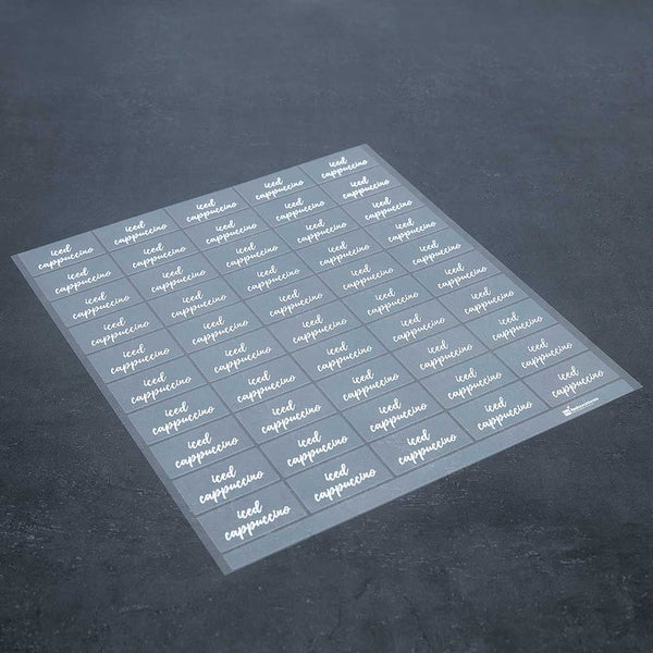 Restaurantware Label Tek Plastic Iced Cappuccino Label - Clear With White Font Water-Resistant - 2" X 1" - 100 Count Box