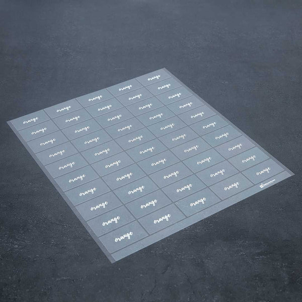 Restaurantware Label Tek Plastic Orange Label - Clear With White Font Water-Resistant - 2" X 1" - 100 Count Box