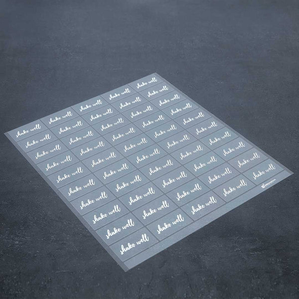 Restaurantware Label Tek Plastic Shake Well Label - Clear With White Font Water-Resistant - 2" X 1" - 100 Count Box