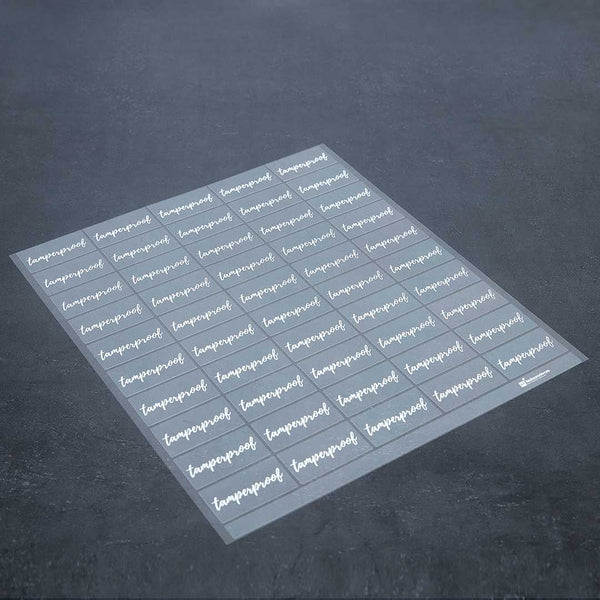 Restaurantware Label Tek Plastic Tamperproof Label - Clear With White Font Water-Resistant - 2" X 1" - 100 Count Box