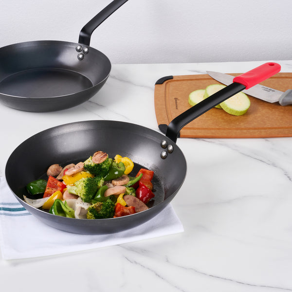 Restaurantware Met Lux 1 Black Carbon Steel 12" Pre-Seasoned Fry Pan And 1 Red Silicone Pan Handle Sleeve