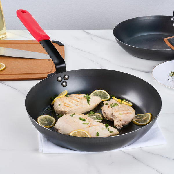 Restaurantware Met Lux 1 Black Carbon Steel 13" Pre-Seasoned Fry Pan And 1 Red Silicone Pan Handle Sleeve