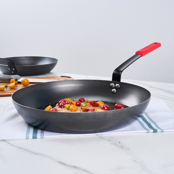 Restaurantware Met Lux 1 Black Carbon Steel 14" Pre-Seasoned Fry Pan And 1 Red Silicone Pan Handle Sleeve