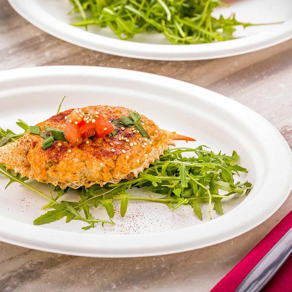 Restaurantware Pulp Tek Oval White Sugarcane / Bagasse Medium Plate - 10 1/2" X 7 3/4" X 3/4" - 100 Count Box