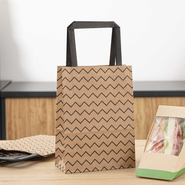 Restaurantware Saving Nature Kraft Paper Small Retail Bag - Black Zig Zag With Handles - 6" X 3 1/4" X 8 1/4" - 100 Count Box
