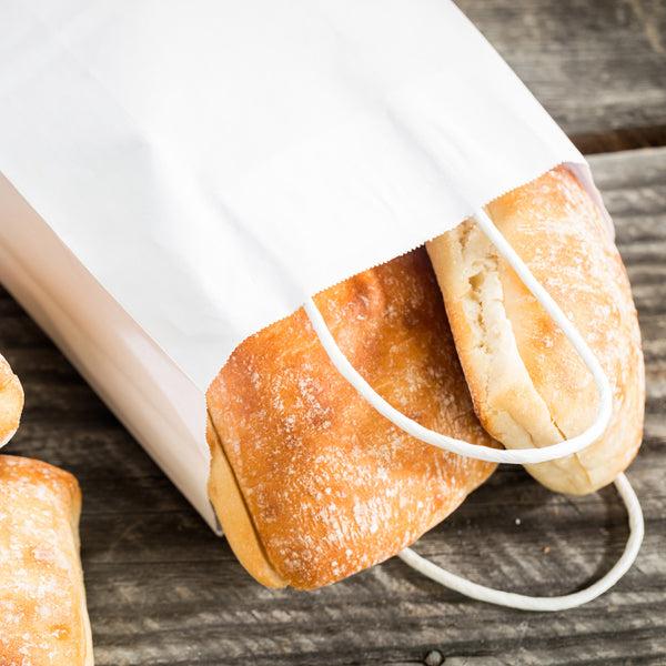 Restaurantware Saving Nature White Paper Medium Retail Bag - With Handles - 10" X 6 3/4" X 12" - 100 Count Box